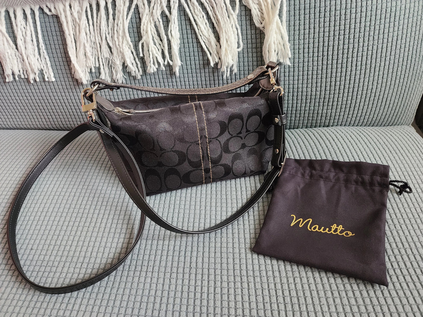 Coach purse with new black leather adjustable cross body strap attached.
